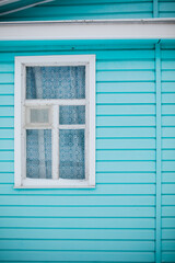 blue wall of a house with a window