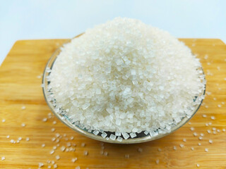 sugar in glass bowl on wooden table