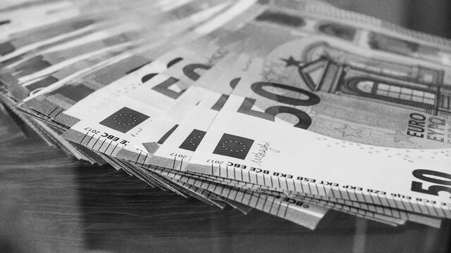Big paper money pile of 50 euro bills or banknotes. Lots of money. Being rich concept. Black and white photo