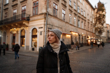Fototapeta na wymiar young woman walks in the evening old town