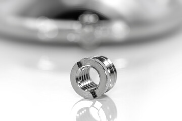 Close up shot of shiny metal threaded insert
