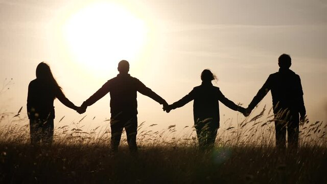 teamwork. team community hold hands together silhouette at sunset unity. business group of people hands. teamwork a workers carry out one mission go the goal. team in the company working partnership