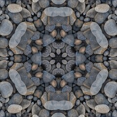 kaleidoscopic style of pebbles on a beach with colourful child's play fork and rake