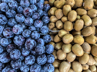 Blue plum and shaggy kiwi on the market. Netanya, Israel