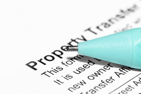 Close up shot of pencil tip showing concept of signing the property transfer document
