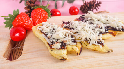 close up view banana roasted with chocolate cheese. indonesian traditional food delicacy. its called Pisang Bakar. selective focus concept
