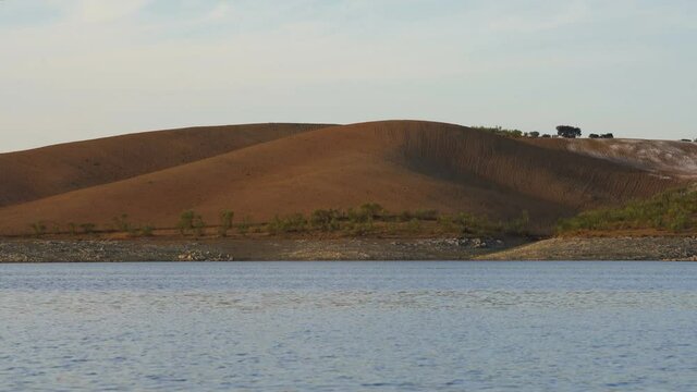 Lucefecit Dam in Terena with reflection on the lake reservoir, in Portugal