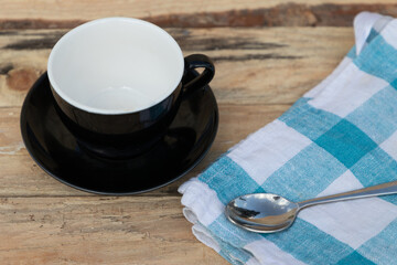 morning coffee with blue tea towel and iron spoon on wooden table
