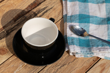 morning coffee with blue tea towel and iron spoon on wooden table