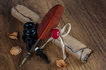 Photograph of a fountain pen with an old inkwell and several differently shaped nibs on papyrus...