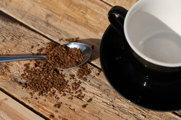 close up morning instant coffee with iron spoon and two biscuit cookies on a wooden table