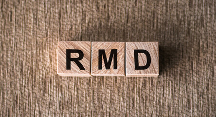 Wooden block with words RMD required minimum distributions.