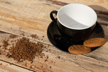 close up morning instant coffee with two biscuit cookies on a wooden table