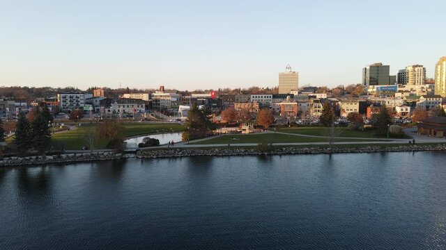 Barrie, Ontario, Canada - Nov 8, 2020: City of Barrie waterfront and downtown aerial drone dolly shot with Lake Simcoe marina, condo buildings, banks, parks and infrastructure. Clear fall day.