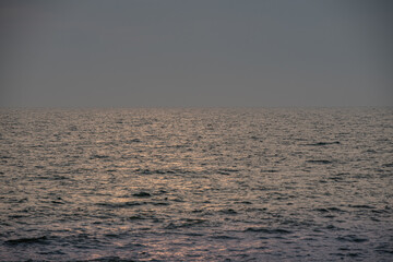 sun behind clouds or fog in the sea