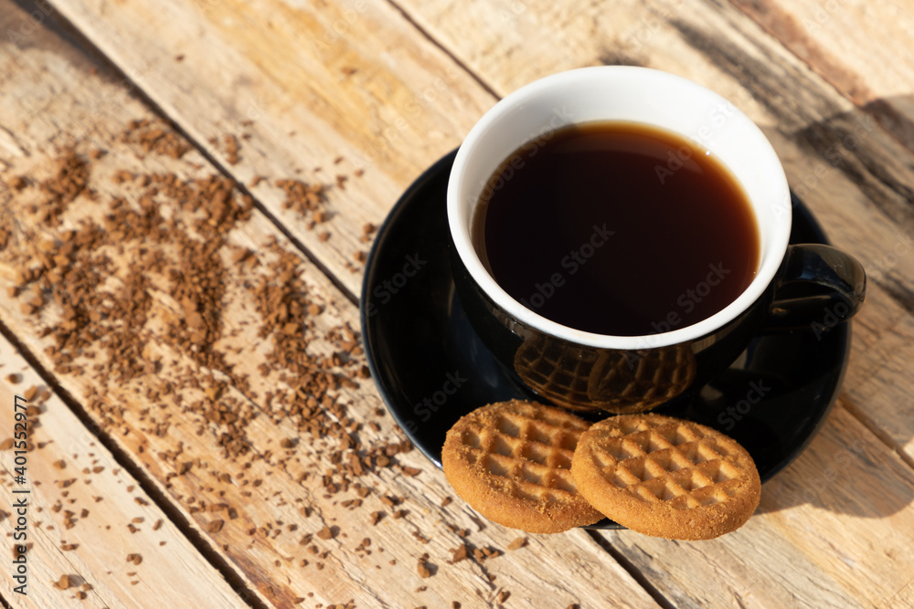 Wall mural close up morning instant coffee with two biscuit cookies on a wooden table