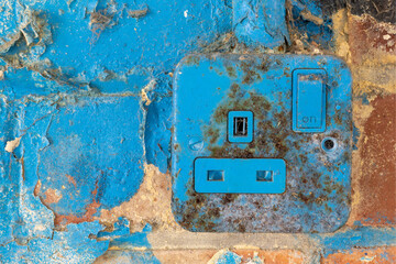 Old wall socket under grafitti