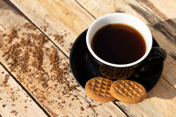 close up morning instant coffee with two biscuit cookies on a wooden table