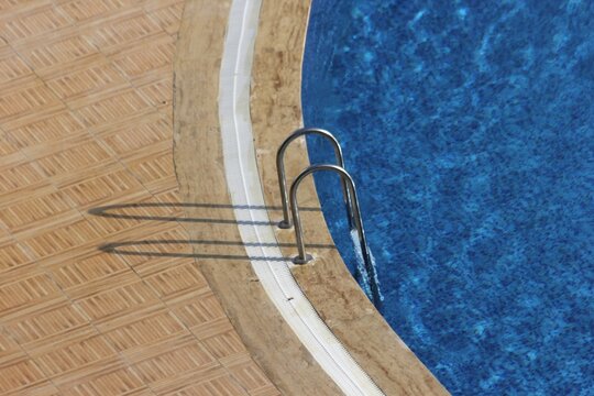photograph of swimming pool area transformed into variations of straight and curved abstract patterns and designs