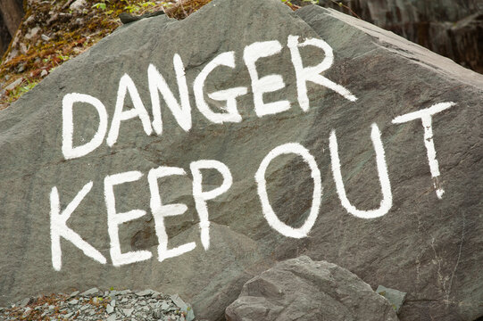 Danger sign painted on rock 5992