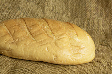 Fresh handmade bread on sackcloth background