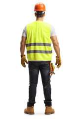 Full length back shot of a construction worker with a helmet and a vest