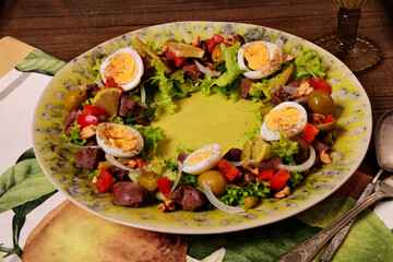 Chicken liver salad in the form of a ring on a green dish. Tinting