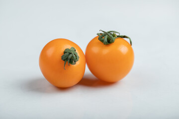 yellow cherry tomatoes isolated on white background. Flat lay, top view.