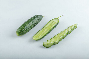 Close-up of fresh green slices of cucumber isolated on white background.