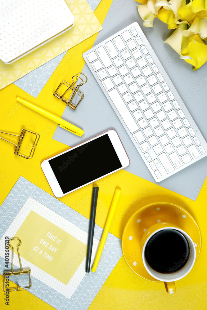 Wall mural 2021 colors of the year, yellow and gray, desktop workspace with keyboard, smart phone and desk acce