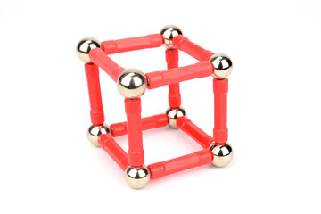 Cube made of balls and sticks of magnetic constructor isolated on a white background