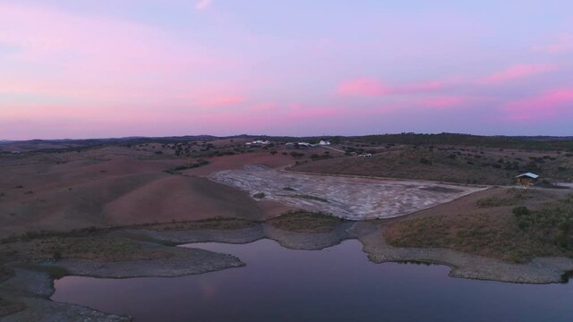 Drone aerial panorama of a desert like hill landscape with marble stones dust at sunset in Terena, Portugal