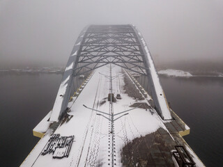 Aerial drone view. A bridge under construction in Kiev in the morning fog.