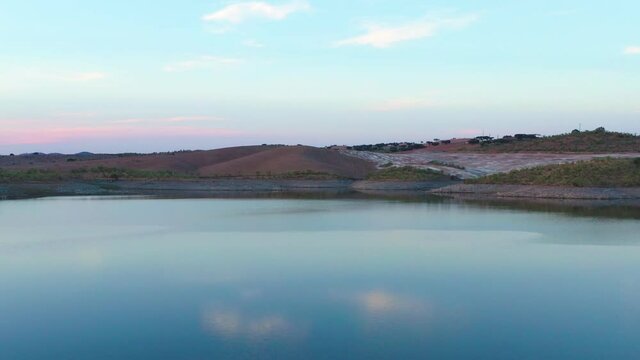 Drone aerial panorama of a desert like hill landscape with marble stones dust at sunset in Terena, Portugal