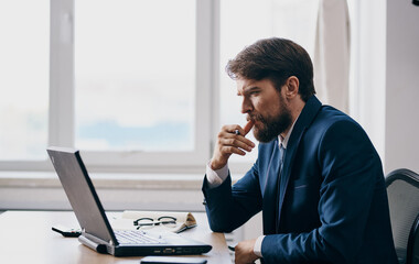 Puzzled business man looks at the laptop at the table in the office work office model