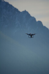 Fototapeta na wymiar drone flying over the mountain, drone that films and takes pictures at height