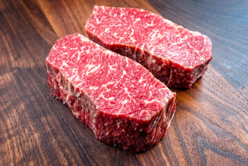 Raw dry aged angus beef fillet steak natural offered as close-up on a modern design plate