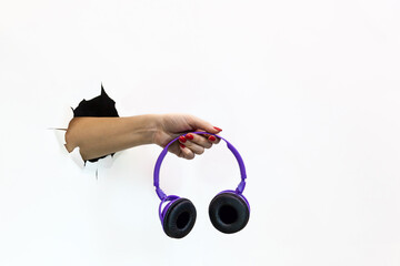 hand holding wireless headphones