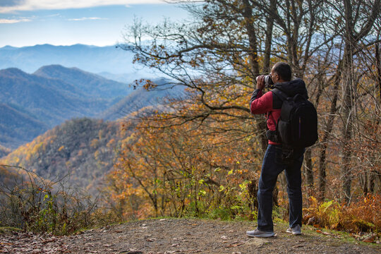 Dark Skinned Man Taking Pictures of Smoky Mountains In Autumn
