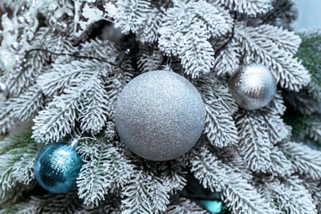 Fototapeta na wymiar Silver Christmas toys on the Christmas tree