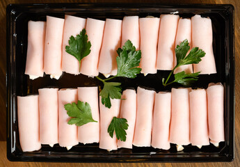 ham rolls stuffed on black background. The view from the top