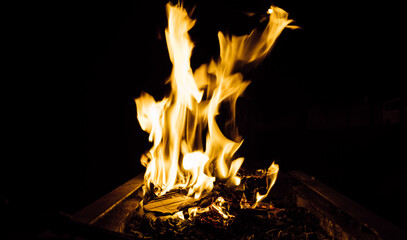 Selective focus. Some areas are blurred. Fire flames and firewood. Abstract photo of wood fire. Campfire made by burning wood. A severe embers fire.