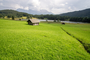 hut on meadows by Geroldsee lake, Bavarian Alps, Germany