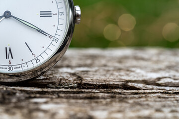 old watch on the wood. Vintage watch as a symbol of passing time. Concept on the theme of history,...