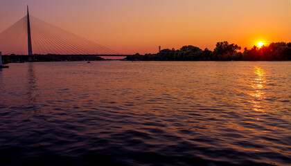 Sunset on Belgrade river named Sava with a huge bridge across the river.