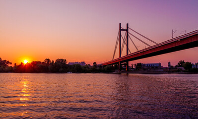 Sunset on Belgrade river named Sava with a huge bridge across the river.