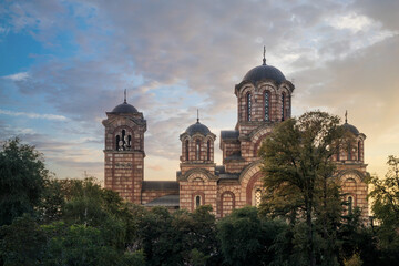 Fototapeta na wymiar St. Mark church in Belgrade at a beautiful sunset and colorful sky. Serbian Orthodox church at sunset, Serbia.