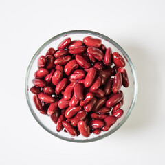 Red beans in a transparent bowl on a white background