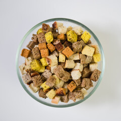 Croutons in a transparent bowl on a white background