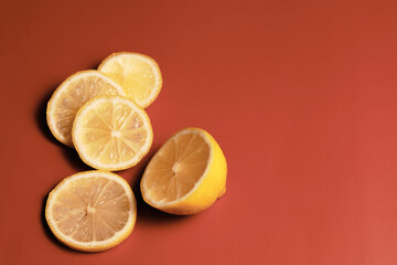 sliced Lemon wedges on the orange surface. Source of vitamin C during cold and flu season. 